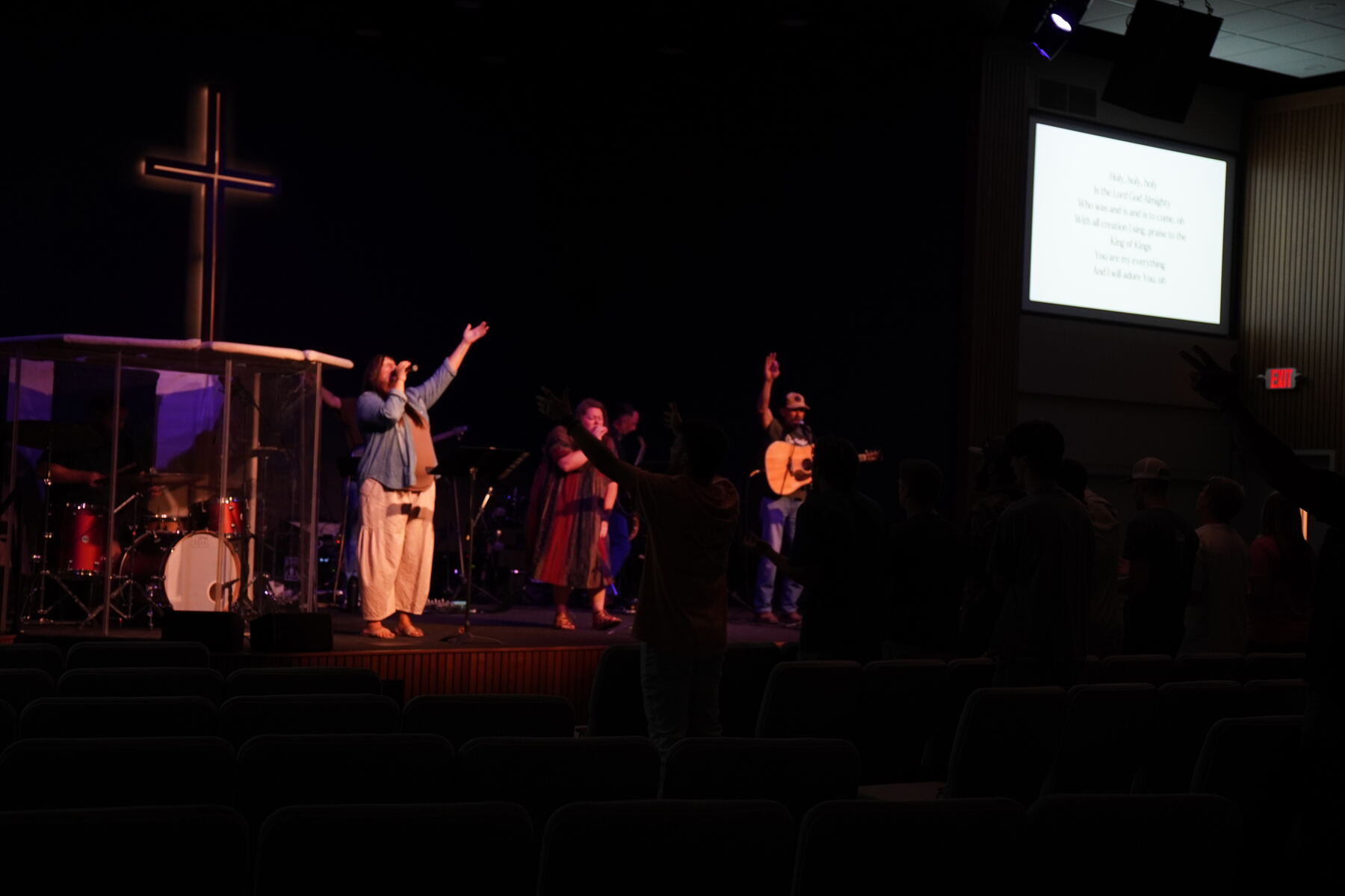 A group kneeling in prayer at the altar