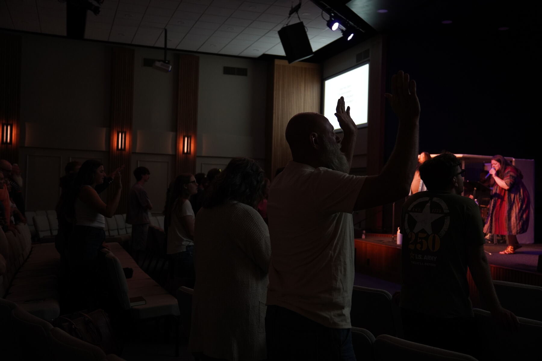 A pastor teaching, pointing to the crowd