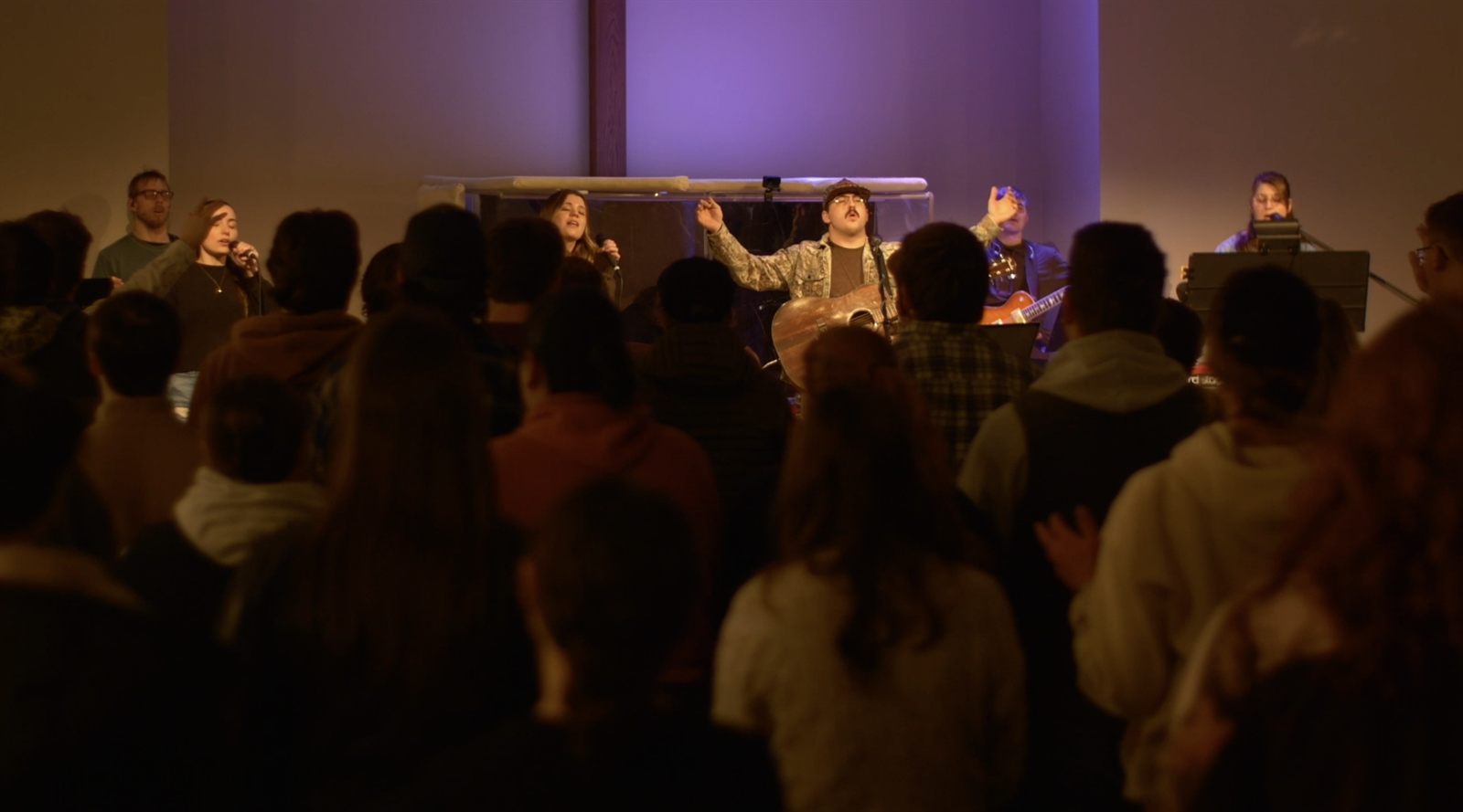 A worship band leads a full room during a Second Saturday night